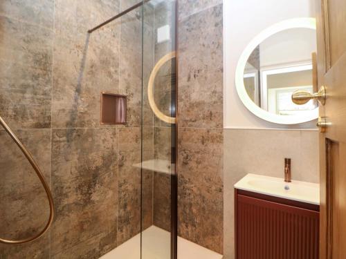 a bathroom with a shower and a sink at The Reading Room in Grindleford Bridge