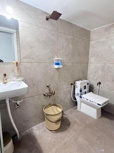 a bathroom with a sink and a toilet at Ardor Homestay in Jabalpur