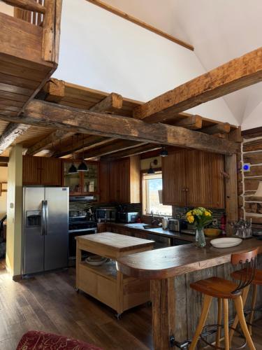 a large kitchen with wooden walls and wooden floors at Yellowstone House in Livingston