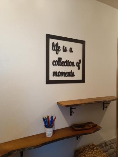 a shelf with aption of moments on a wall at Casa del Norte in Brackenheim