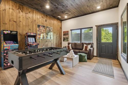 a living room with a large ping pong table at Peak Pursuit by Beyond Expectations w Indoor Pool in Pigeon Forge