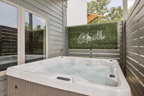 a large bath tub in a room with a window at Peak Pursuit by Beyond Expectations w Indoor Pool in Pigeon Forge