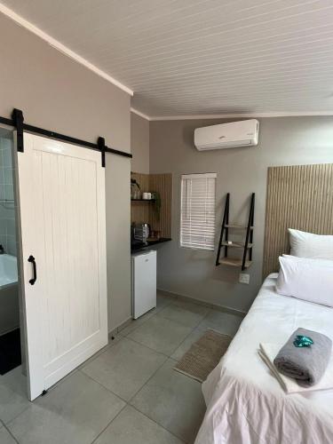 a bedroom with a bed and a white door at Stay at Tzaneen in Tzaneen