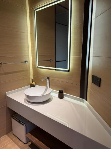 a bathroom with a white sink and a mirror at Pudina Resort in Semporna