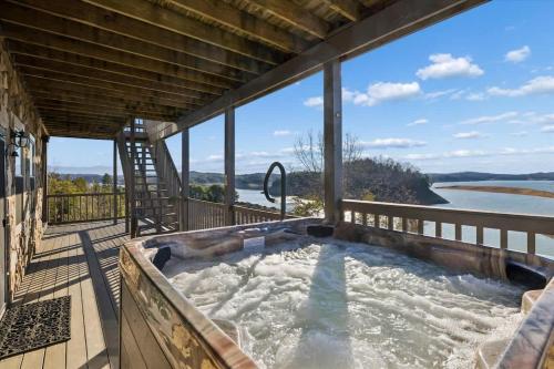 a hot tub on the deck of a house at Lighthouse Lookout by Beyond Expectations - Hot Tub & Lake Views in Sevierville