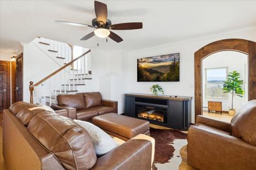 a living room with a couch and a fireplace at Lighthouse Lookout by Beyond Expectations - Hot Tub & Lake Views in Sevierville
