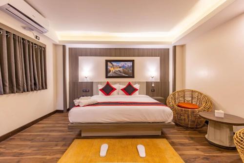 a hotel room with a bed and a table at The Resident Kathmandu in Kathmandu