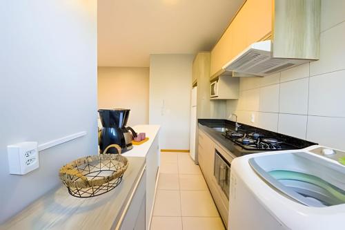 a small kitchen with a stove and a sink at Curta Praia do Quilombo - Lunata in Penha