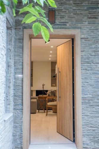 a door leading into a room with a living room at THALIA, luxury 3Br Home with Ensuite Bathrooms, just 3 minutes walk from the beach located in the prestigious Athenian Riviera in Athens