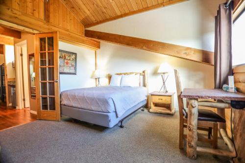 a bedroom with a bed and a wooden ceiling at The Boulder Creek Lodge in Nederland