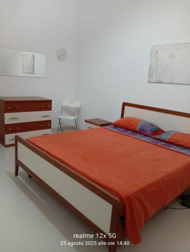 a bedroom with a bed and a dresser at Vico Girone in Patti