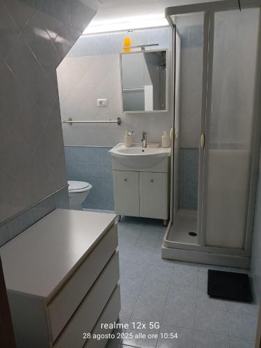 a bathroom with a shower and a sink and a toilet at Vico Girone in Patti