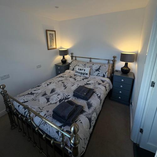 a bedroom with a bed with two pillows on it at Santa's Cottage in Torquay
