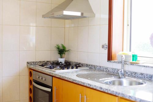 a kitchen with a sink and a counter top at Casa Fundevila Celorico de Basto in Celorico de Basto