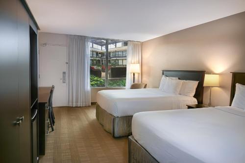 a hotel room with two beds and a window at Skyline Hotel & Waterpark in Niagara Falls