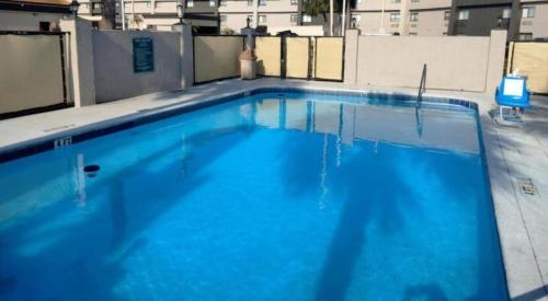 a large blue swimming pool on top of a building at Baymont by Wyndham Orlando South in Orlando