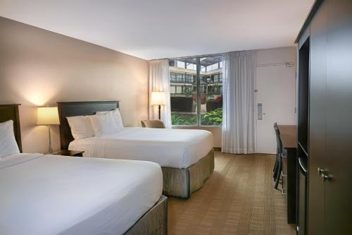a hotel room with two beds and a window at Skyline Hotel & Waterpark in Niagara Falls