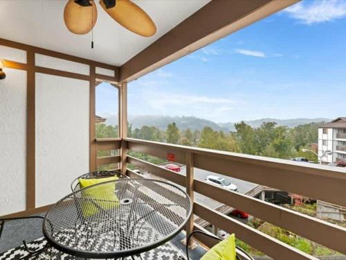 a balcony with a table and a view at Turkey Nest by Beyond Expectations Renovated 2BR in Gatlinburg