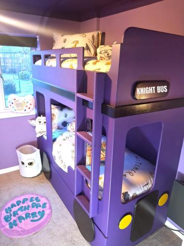 a purple bunk bed with bunk beds in a room at Rooms of Requirement in Watford