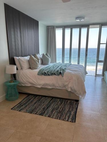 a bedroom with a bed with a view of the ocean at Sea View Bliss in Ballito