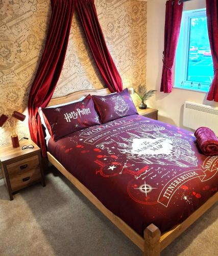 a bedroom with a bed with a canopy at Rooms of Requirement in Watford