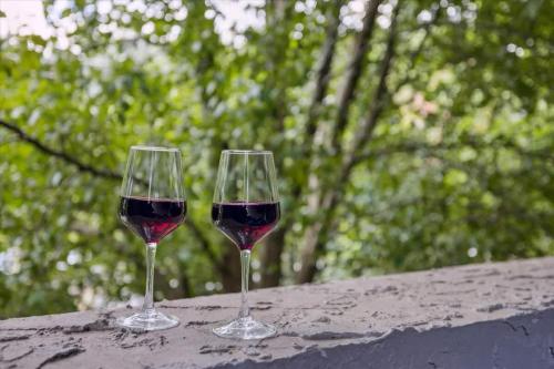 two glasses of red wine sitting on a table at Baskins Creek II by Beyond Expectations w Balcony in Gatlinburg