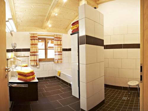 a bathroom with a tub and a sink at Wimmerhof - Chiemgau Karte in Inzell
