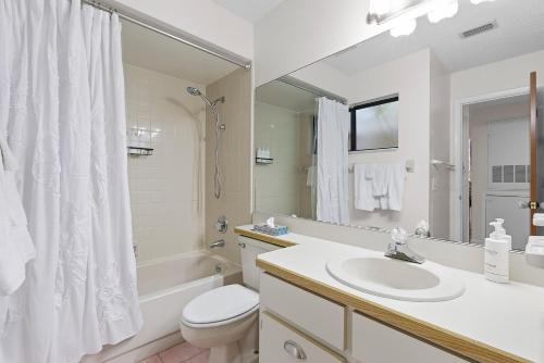 a white bathroom with a sink and a toilet at Sea Woods Villa 4263 in New Smyrna Beach