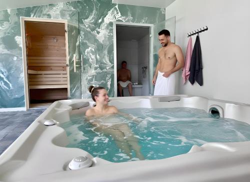 a man and a woman in a bath tub at Hotel Le Provence - Restaurant Le Styx in La Palud-sur-Verdon