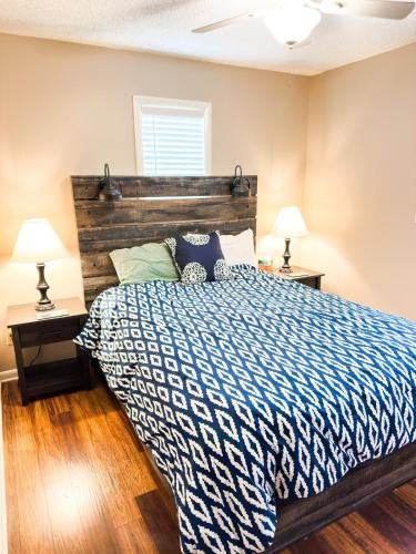 a bedroom with a large bed with a wooden headboard at Massanutten Chalet View & Fire Table Deck in McGaheysville