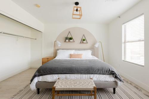 a white bedroom with a large bed and a window at Copper Cactus House Pool, Spa, Golf! in Queen Creek