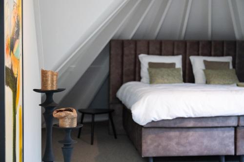 a bedroom with a bed with a wooden headboard at Suite Het Koetshuis in Bennekom