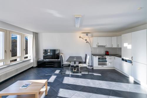 a kitchen with a table and chairs in a room at CENTRO Appartamento Ascona in Ascona