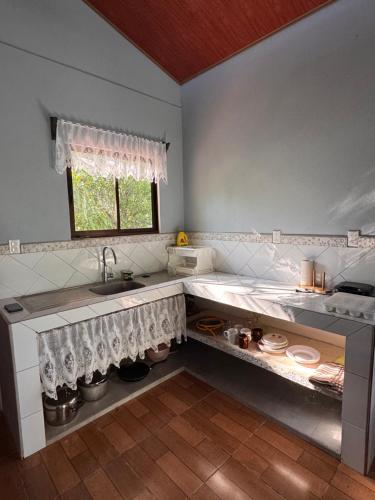 a kitchen with a sink and a window at Casa Almendros in Cabuya