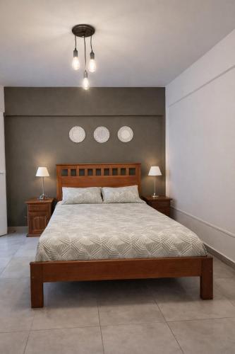 a bedroom with a bed with two night stands and two lamps at Departamento Palomar in Posadas