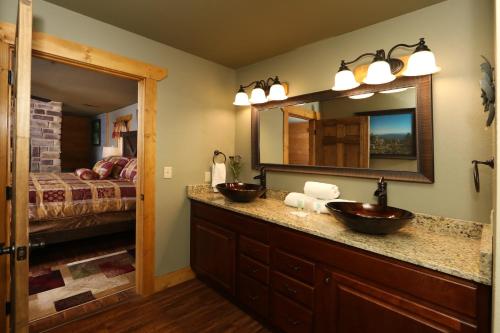 a bathroom with two sinks and a mirror at Firefly Nights – 5-Bed Mountain Chalet with Private Theater and Elevator in Gatlinburg