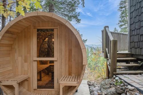 a wooden sauna with a bench in a backyard at Elk Run in Whitefish