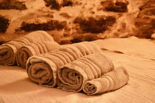 a row of towels sitting on a bed at Mesta Loft in Mestá