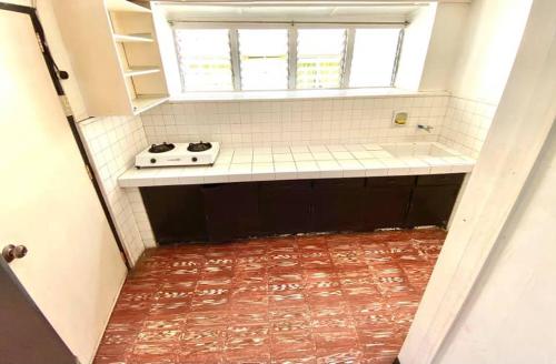a small bathroom with a sink and a window at Tamari's Rest House in Lian