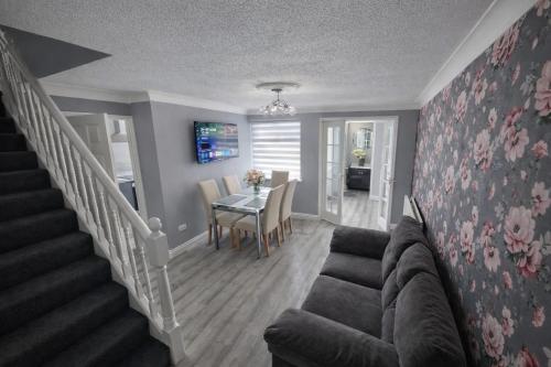 a living room with a couch and a table at Cloverdale in Bedlington