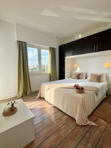 a bedroom with a large bed and a wooden floor at Apartment STAR Blažev in Primošten