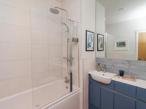 a bathroom with a shower and a sink at Cuddy's Holm in Seahouses