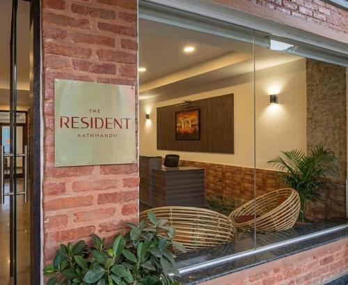 a window of a restaurant with a sign on it at The Resident Kathmandu in Kathmandu