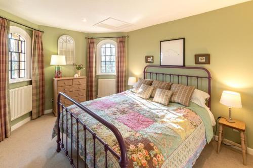 a bedroom with a bed and two windows at 2 Bed in Tunstall oc-ivylod in Rendlesham