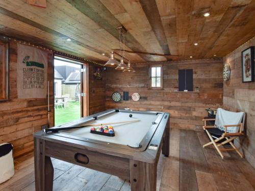 a pool table in a room with wooden walls at 6 Bed in Rye- oc-89037 in Camber
