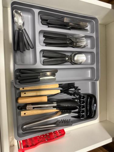 a drawer full of utensils in a refrigerator at Carvalho Home in Londrina