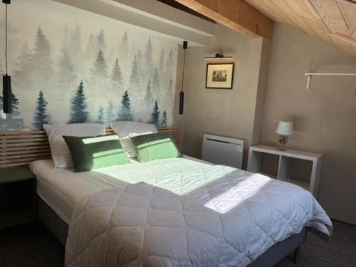 a bedroom with a bed and a painting of trees at Loft Cocooning et Lumineux in Arbois