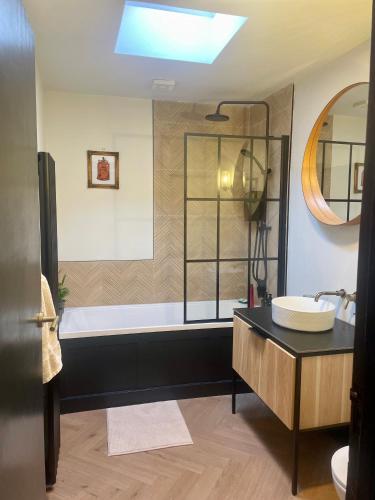 a bathroom with a tub and a sink at Dublin City Centre Holiday Let in Dublin