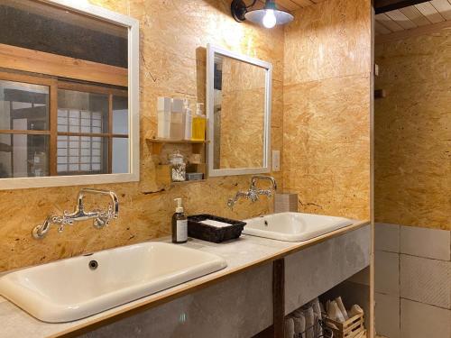 a bathroom with two sinks and a mirror at La Cachette - Vacation STAY 34953v in Ina