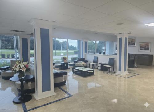 a lobby with couches and tables in a building at Noble Suites in Albany